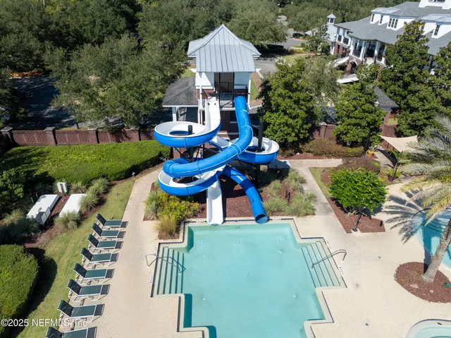 an aerial view of a house with garden space and street view