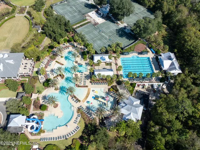an aerial view of residential house with outdoor space and swimming pool
