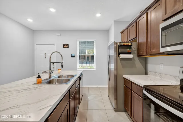 a kitchen with stainless steel appliances granite countertop a sink and stove