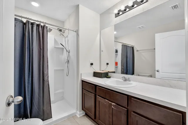 a bathroom with a sink double vanity and a mirror