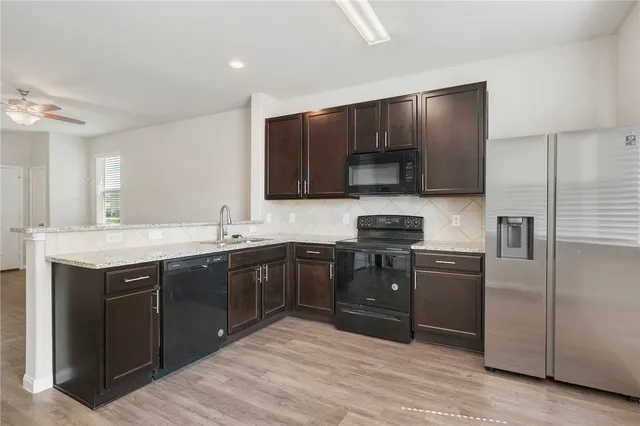 a kitchen with a sink cabinets and stainless steel appliances