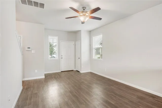 wooden floor in an empty room with a window