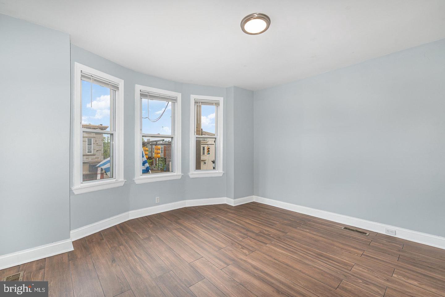 4600 Eastern Avenue Baltimore, MD 21224 - Photo 14 of 25 an empty room with wooden floor and windows