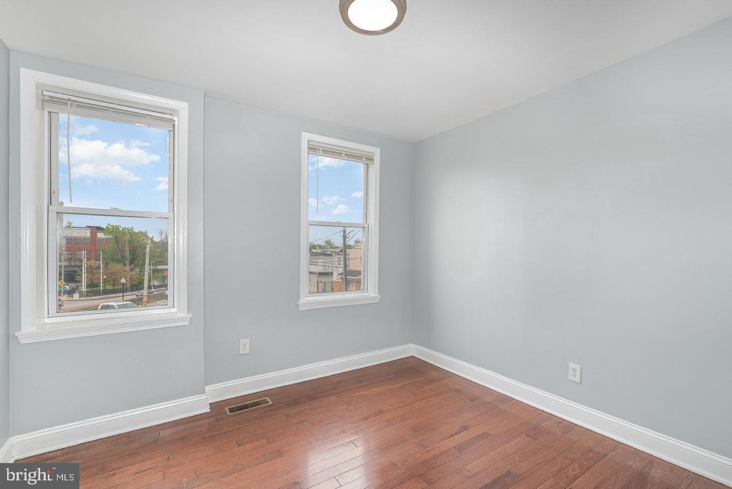 4600 Eastern Avenue Baltimore, MD 21224 - Photo 20 of 25 an empty room with wooden floor and windows