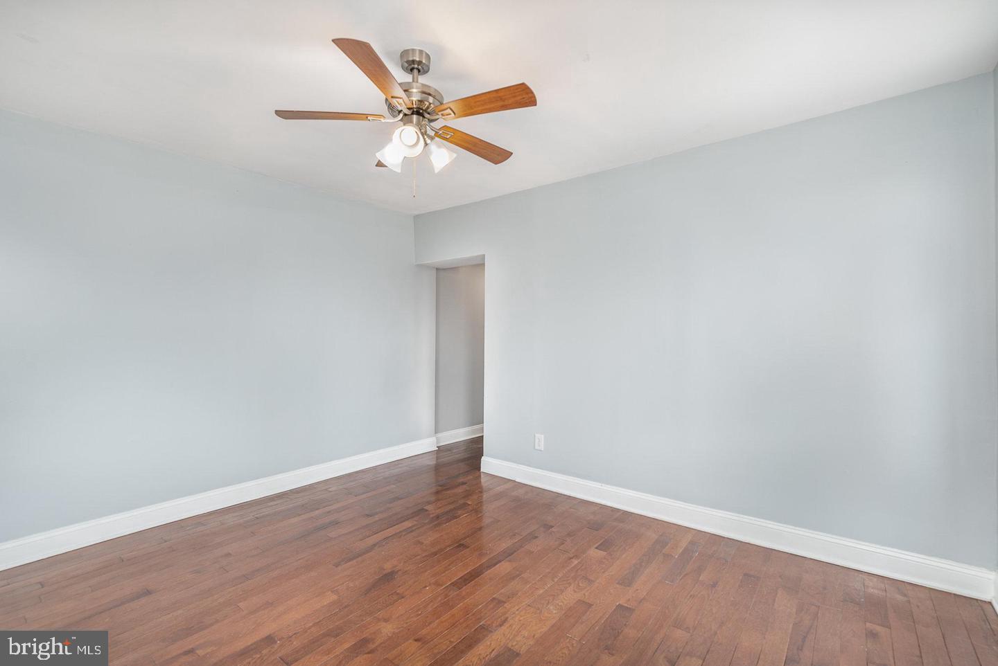 4600 Eastern Avenue Baltimore, MD 21224 - Photo 6 of 25 an empty room with wooden floor fan and windows