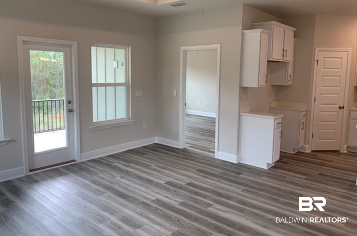 12904 Grand Rpds Road Fairhope, AL 36532 - Photo 19 of 34 Kitchen with white cabinetry and dark hardwood / wood-style floors