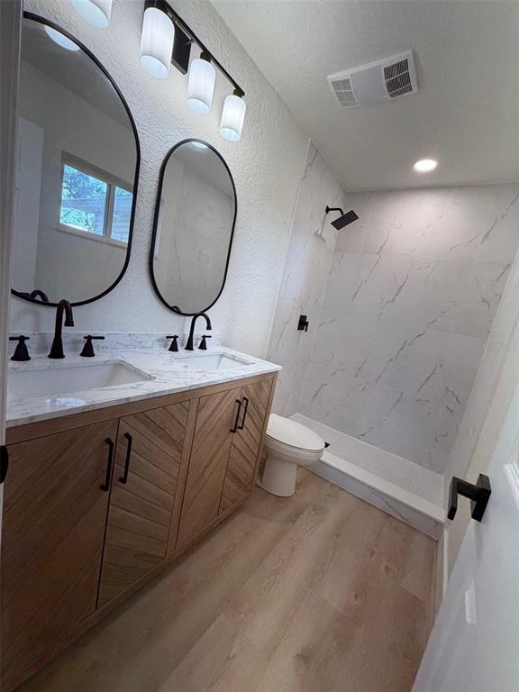 5342 Broken Pine Circle Orlando, FL 32818 - Photo 12 of 15 a bathroom with a double vanity sink mirror and toilet