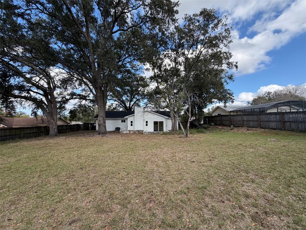 5342 Broken Pine Circle Orlando, FL 32818 - Photo 15 of 15 a house with trees in front of it