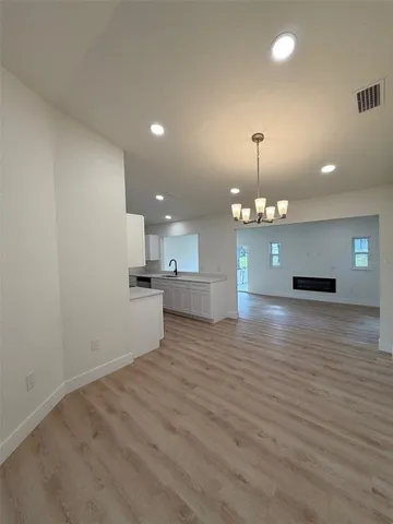 a large white kitchen with stainless steel appliances