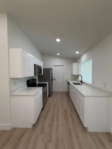 a kitchen with sink and cabinets