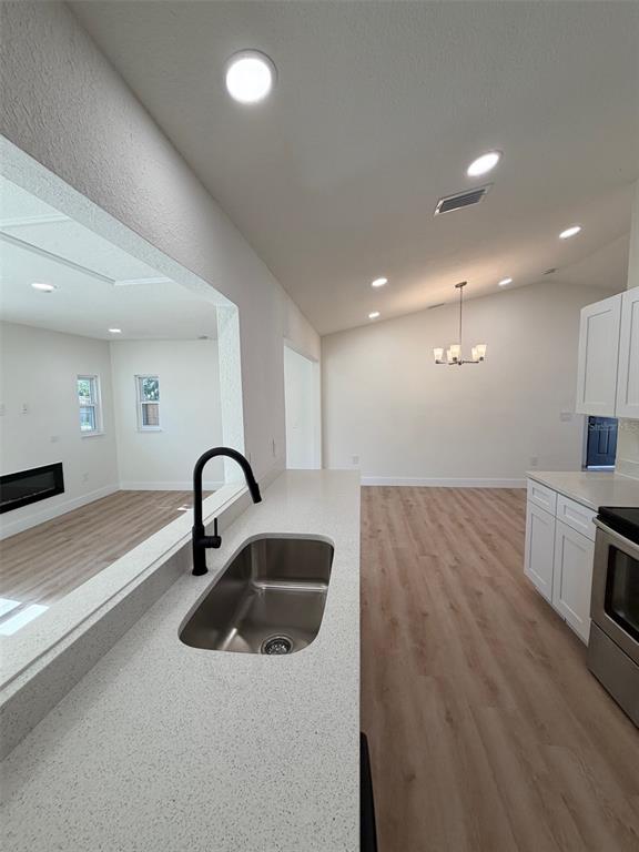 5342 Broken Pine Circle Orlando, FL 32818 - Photo 6 of 15 a kitchen with kitchen island a sink appliances and a counter top