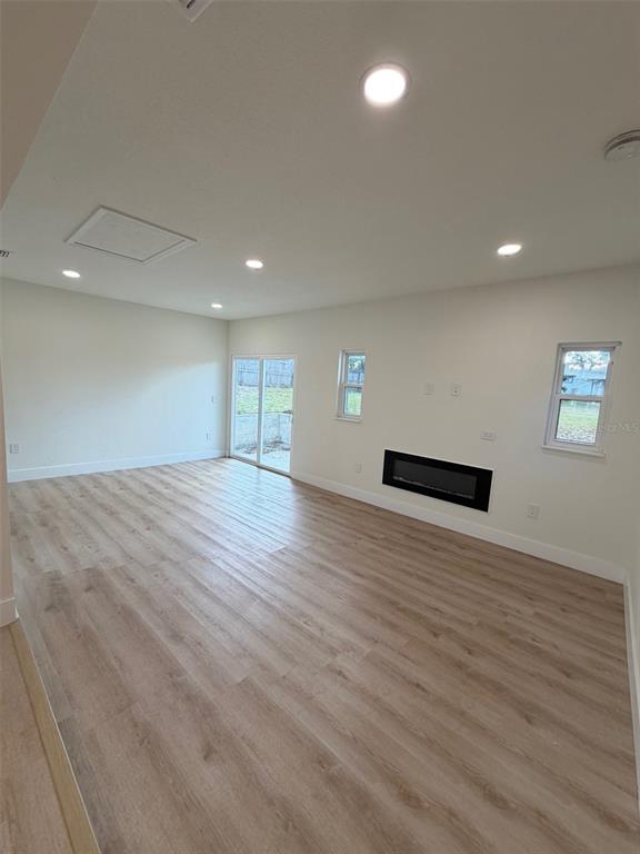 5342 Broken Pine Circle Orlando, FL 32818 - Photo 7 of 15 a view of an empty room with wooden floor and a window