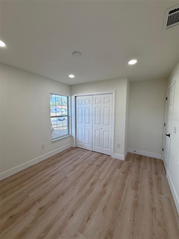 5342 Broken Pine Circle Orlando, FL 32818 - Photo 10 of 15 a view of an empty room with wooden floor and a window