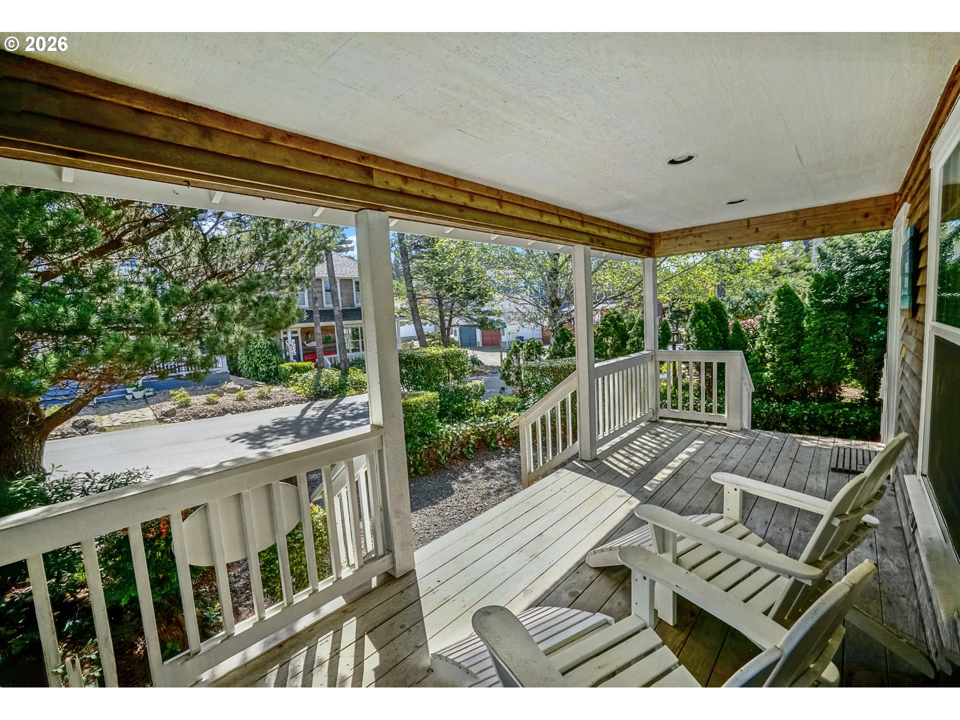 265 Bunchberry Way Depoe Bay, OR 97341 - Photo 2 of 48 a view of a patio with table and chairs potted plants with floor to ceiling window