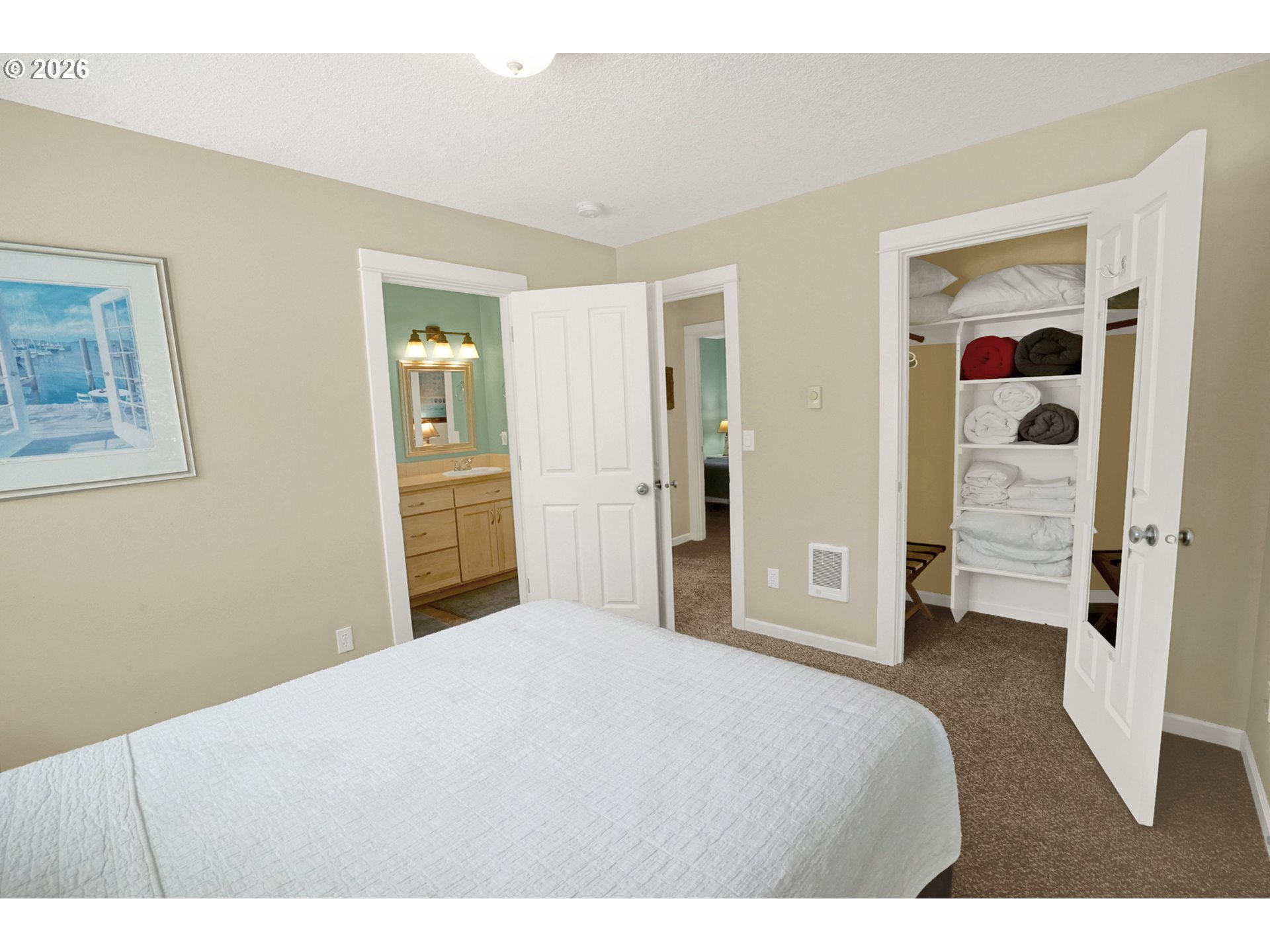 265 Bunchberry Way Depoe Bay, OR 97341 - Photo 25 of 48 a bedroom with a bed and a refrigerator