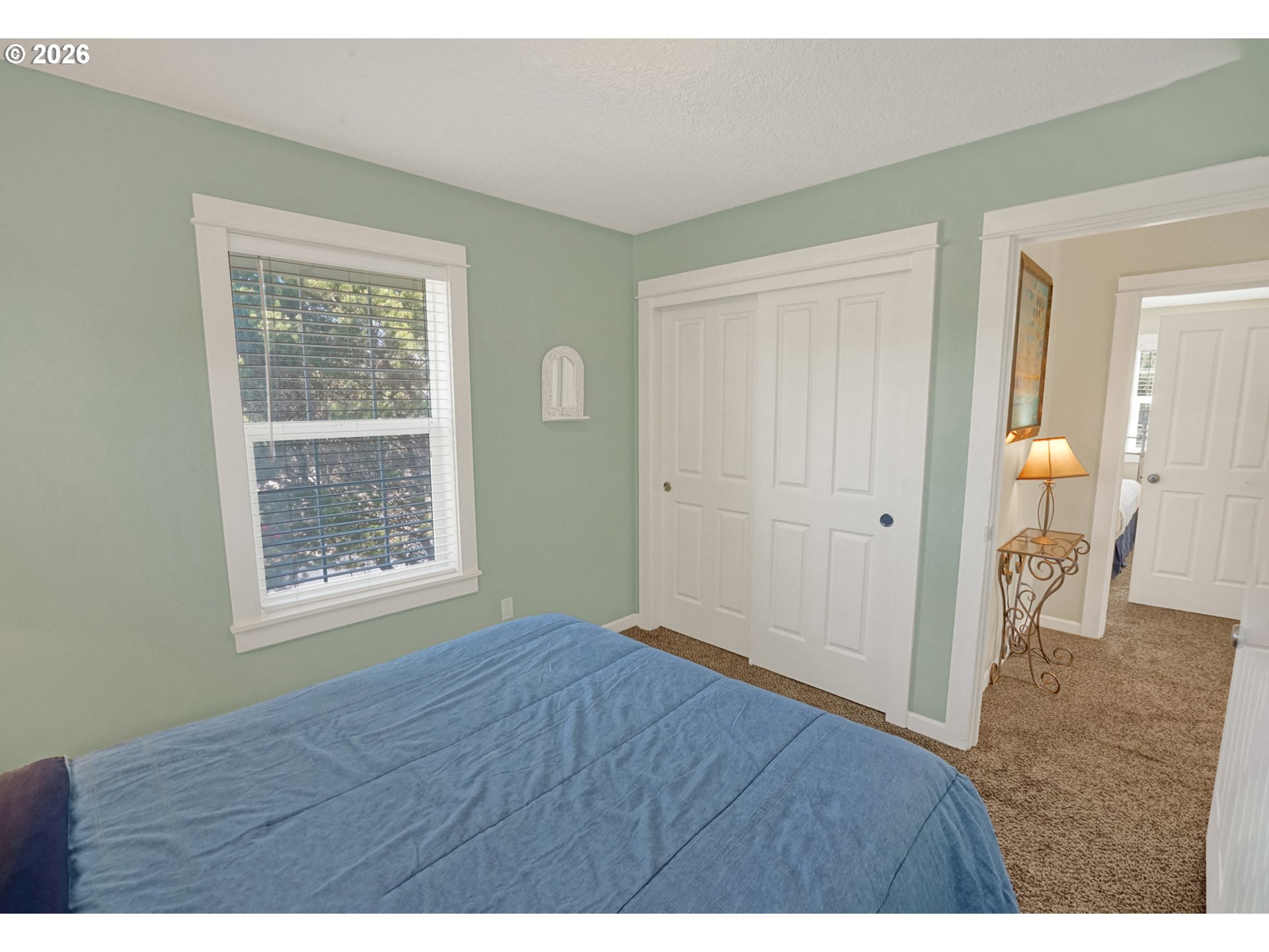 265 Bunchberry Way Depoe Bay, OR 97341 - Photo 31 of 48 a view of an empty room with wooden floor and a bedroom