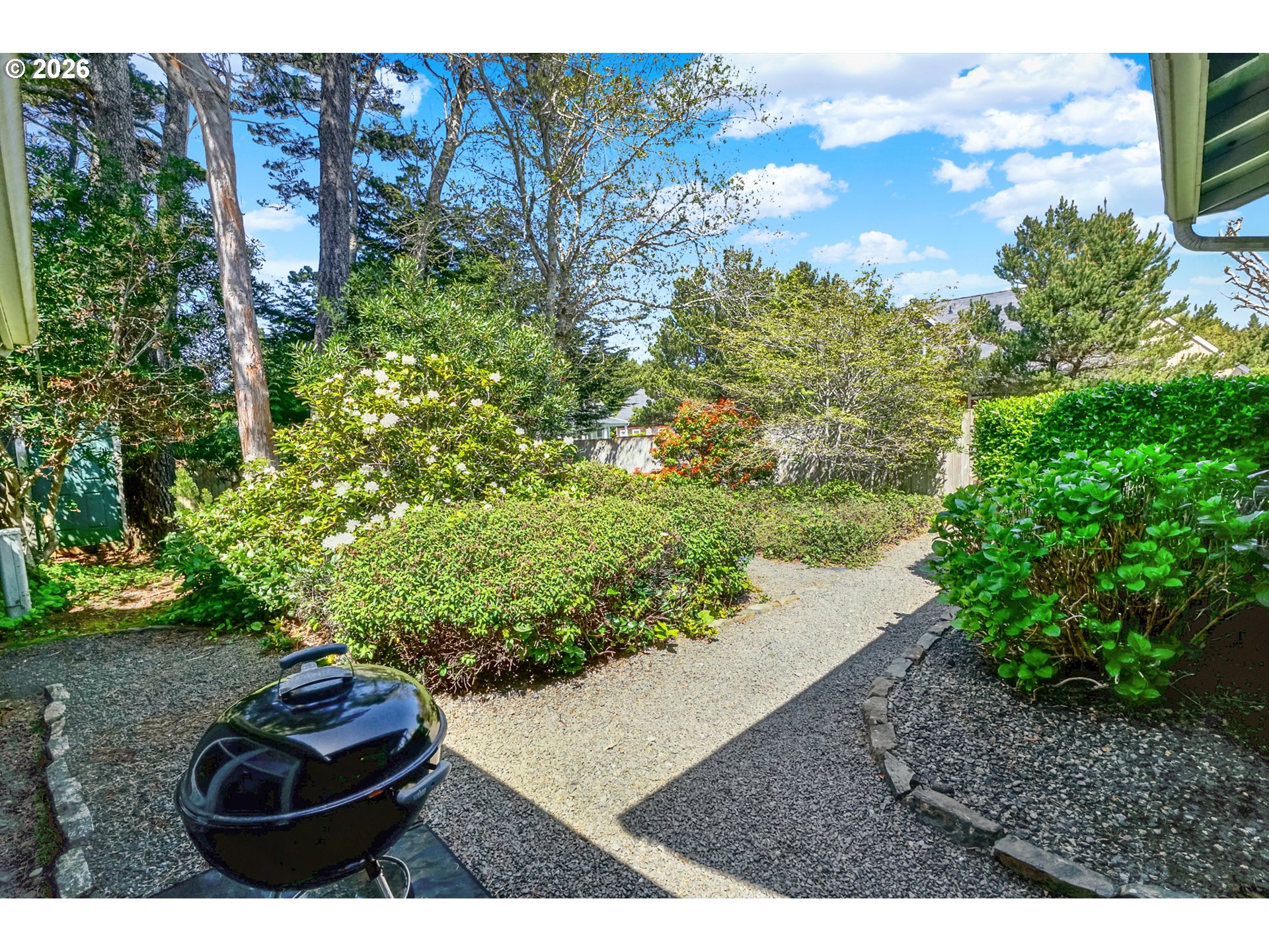 265 Bunchberry Way Depoe Bay, OR 97341 - Photo 39 of 48 a backyard of a house with a yard and outdoor seating