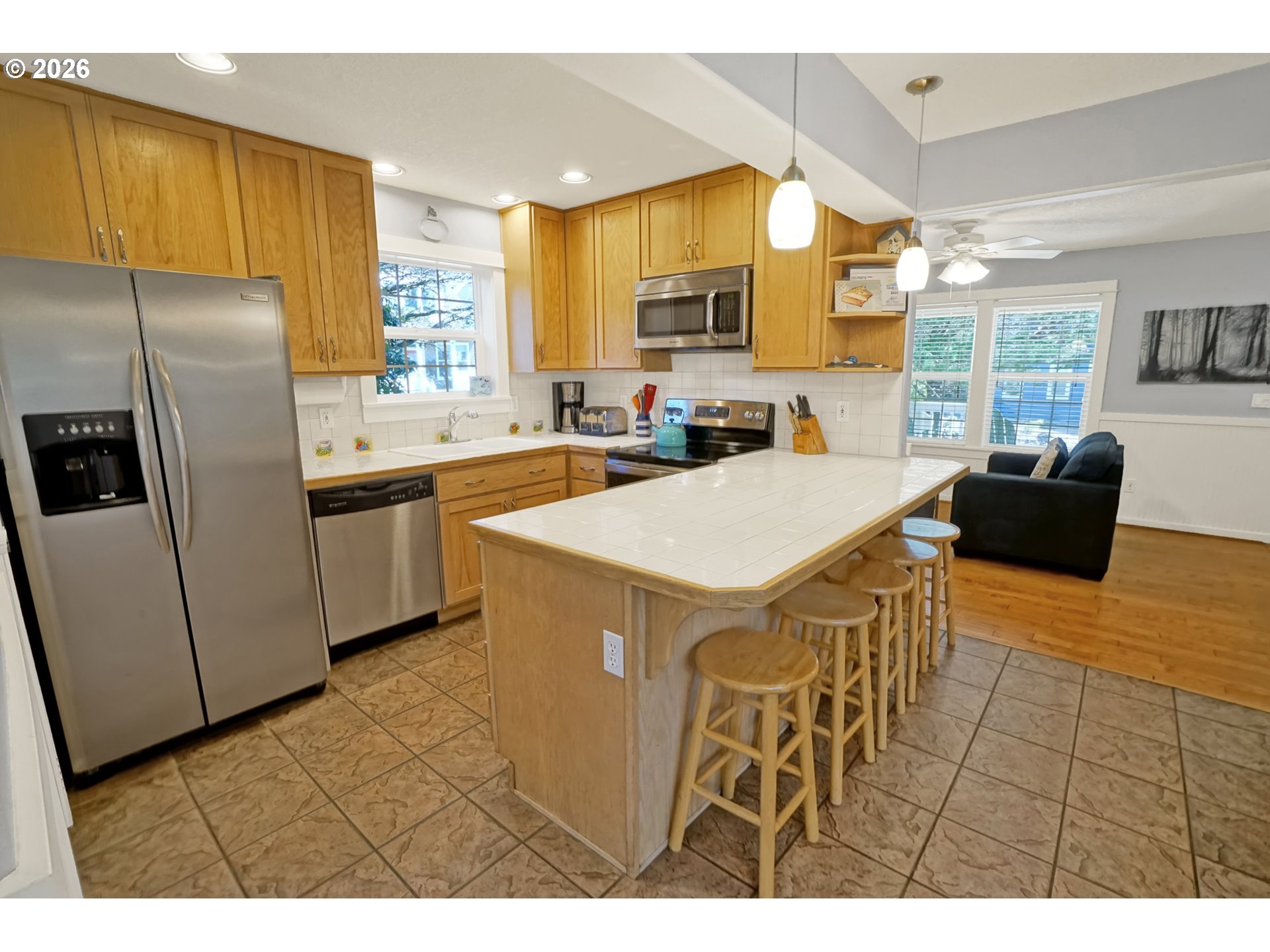 265 Bunchberry Way Depoe Bay, OR 97341 - Photo 10 of 48 a kitchen with stainless steel appliances a refrigerator a sink a stove and white cabinets