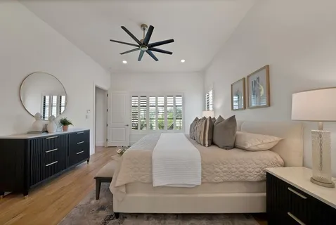 a bedroom with a large bed and a dresser