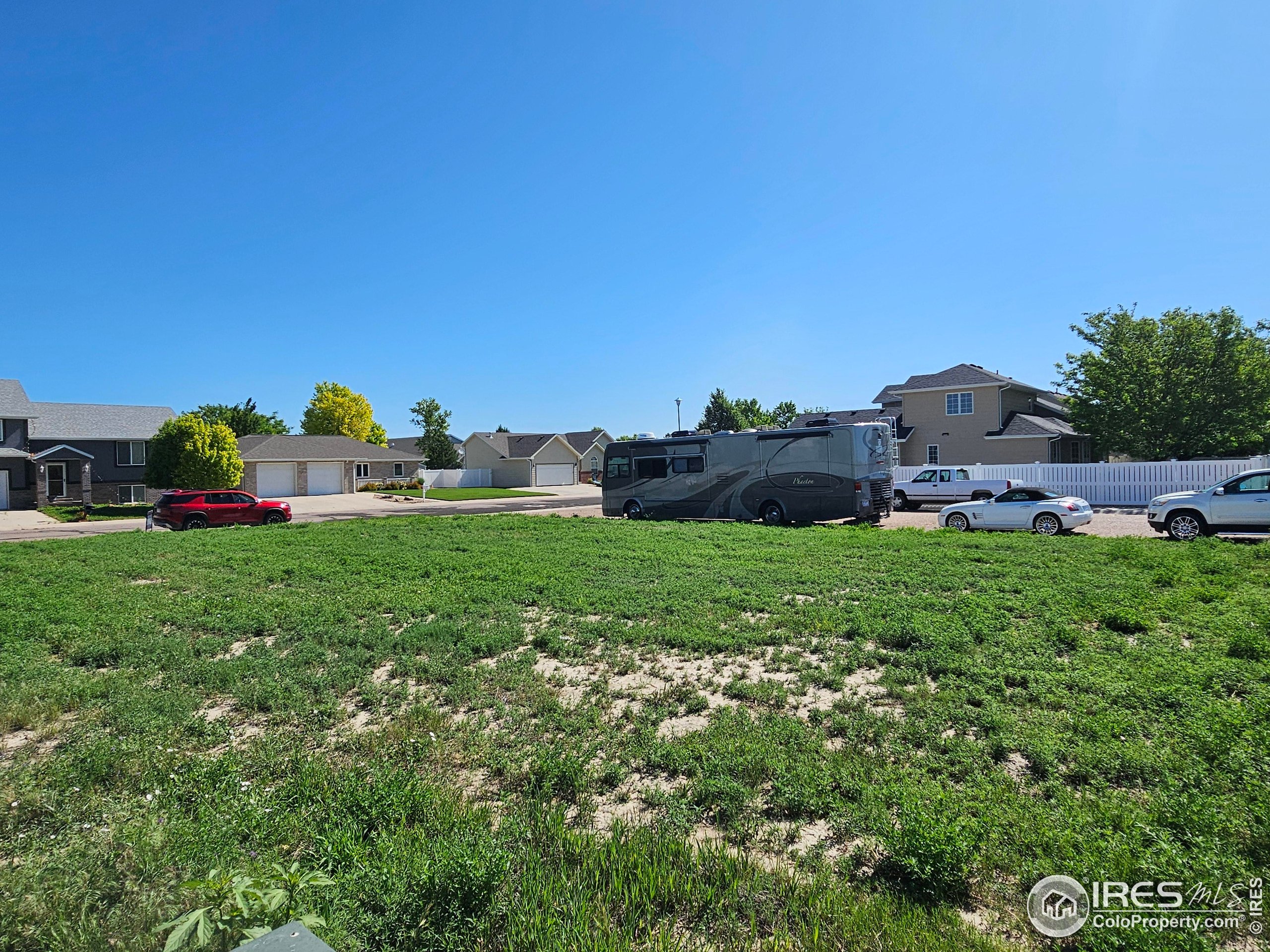 829 Nicole Road Sterling, CO 80751 - Photo 9 of 14 a view of yard with house and car parked in the background