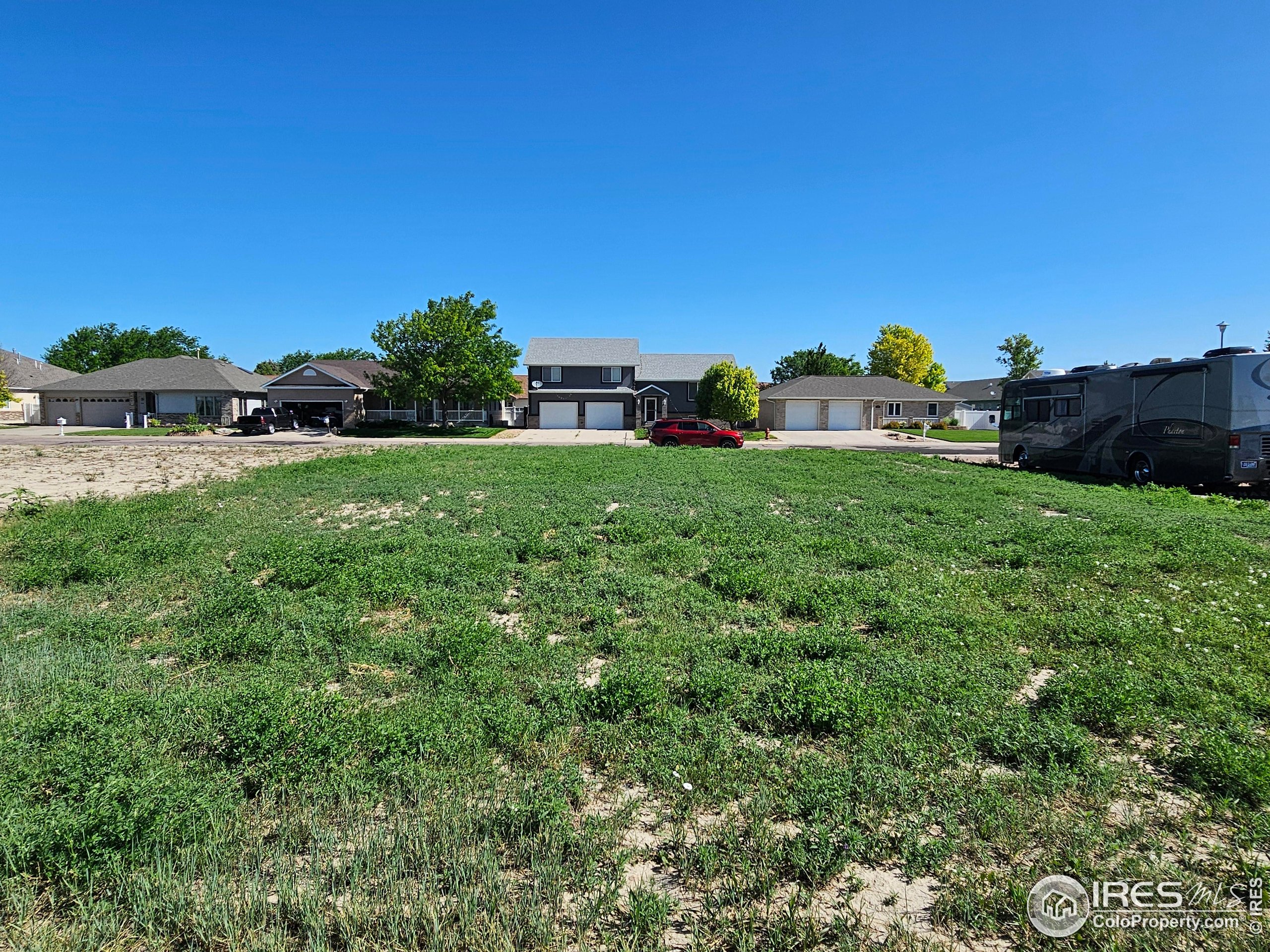 829 Nicole Road Sterling, CO 80751 - Photo 10 of 14 a view of a large garden with a building in the background