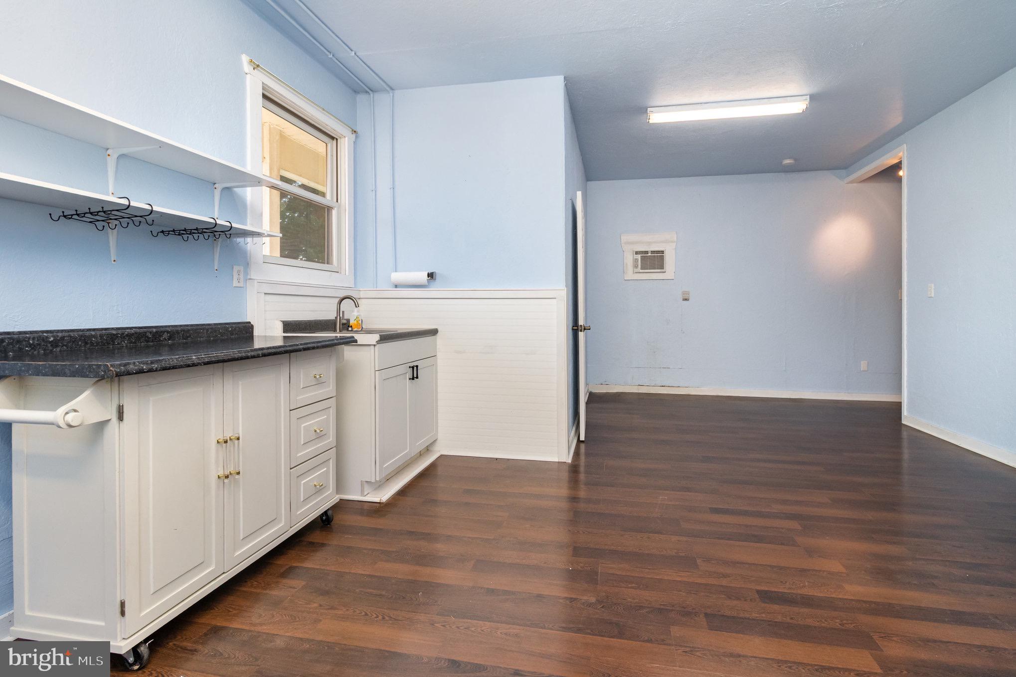 687 Prospect Hill Road Montross, VA 22520 - Photo 54 of 80 a kitchen with stainless steel appliances granite countertop a sink a stove and wooden floors