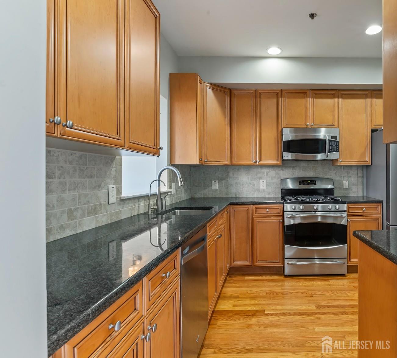 142 Conover Terrace Lebanon, NJ 08833 - Photo 9 of 33 a kitchen with stainless steel appliances granite countertop a stove a sink and a microwave