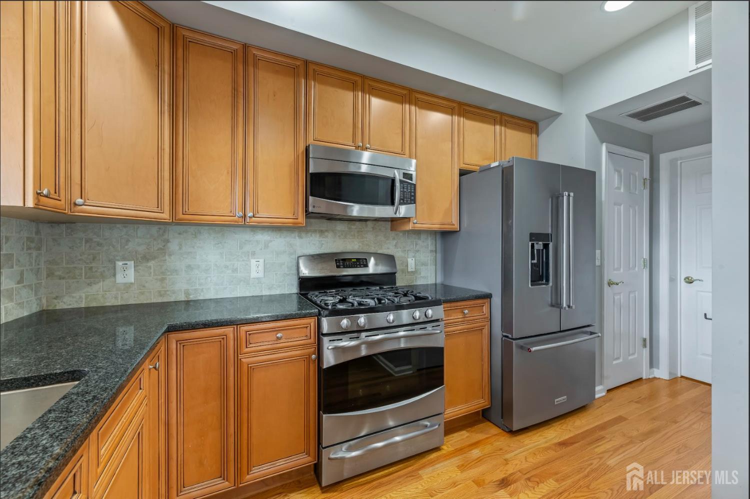 142 Conover Terrace Lebanon, NJ 08833 - Photo 10 of 33 a kitchen with stainless steel appliances granite countertop a stove a refrigerator and a microwave