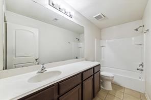 4910 Pacific Ridge Lane Rosenberg, TX 77469 - Photo 12 of 14 a bathroom with a sink a toilet a tub and a mirror