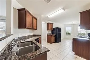 a kitchen with a sink cabinets and stainless steel appliances