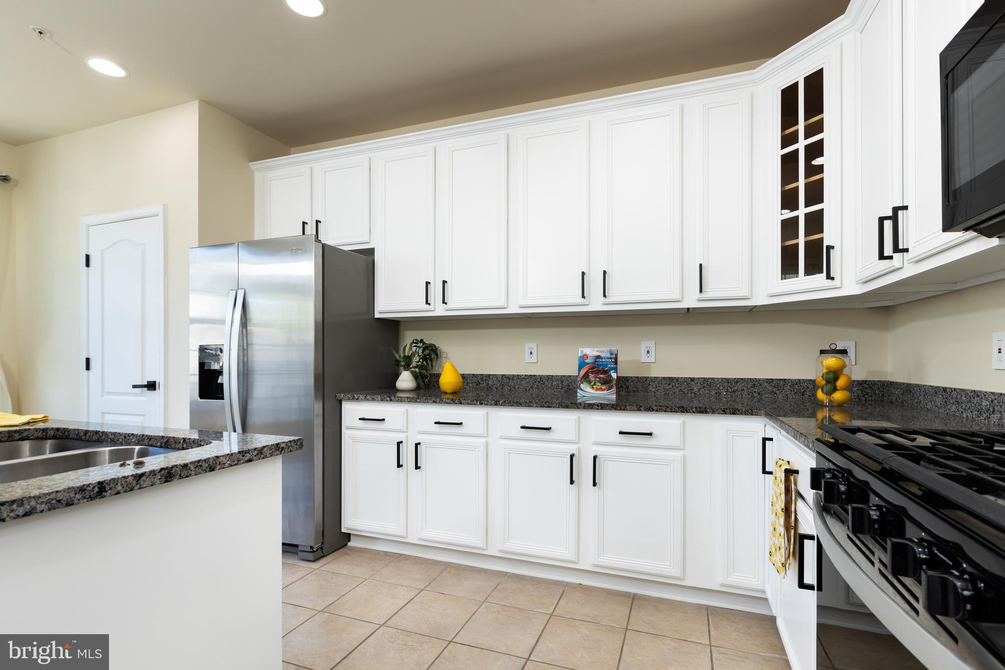 637 Spectator Avenue Landover, MD 20785 - Photo 11 of 54 a kitchen with stainless steel appliances a stove cabinets and a refrigerator