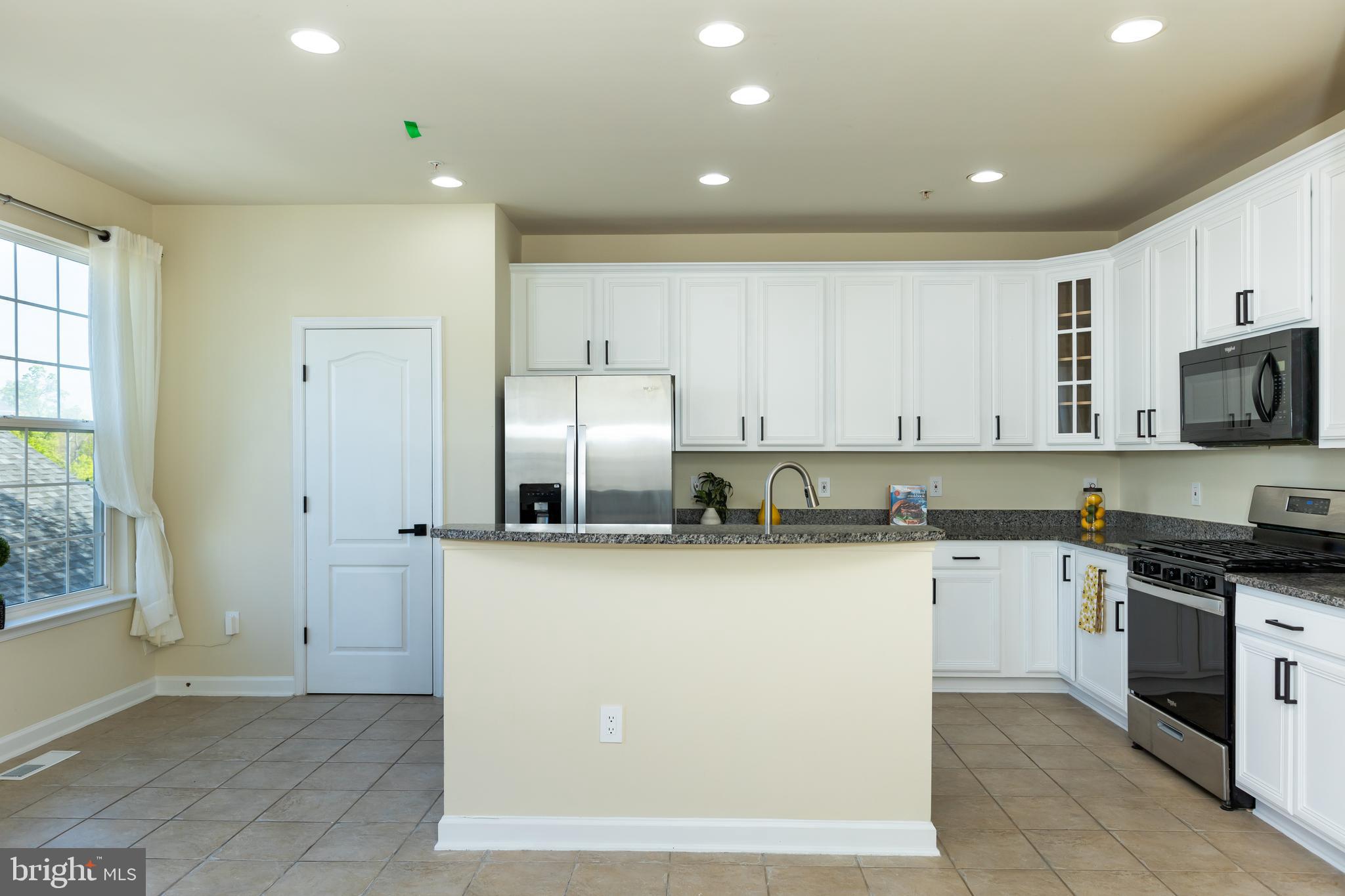 637 Spectator Avenue Landover, MD 20785 - Photo 13 of 54 a kitchen with stainless steel appliances granite countertop a stove a sink and a refrigerator