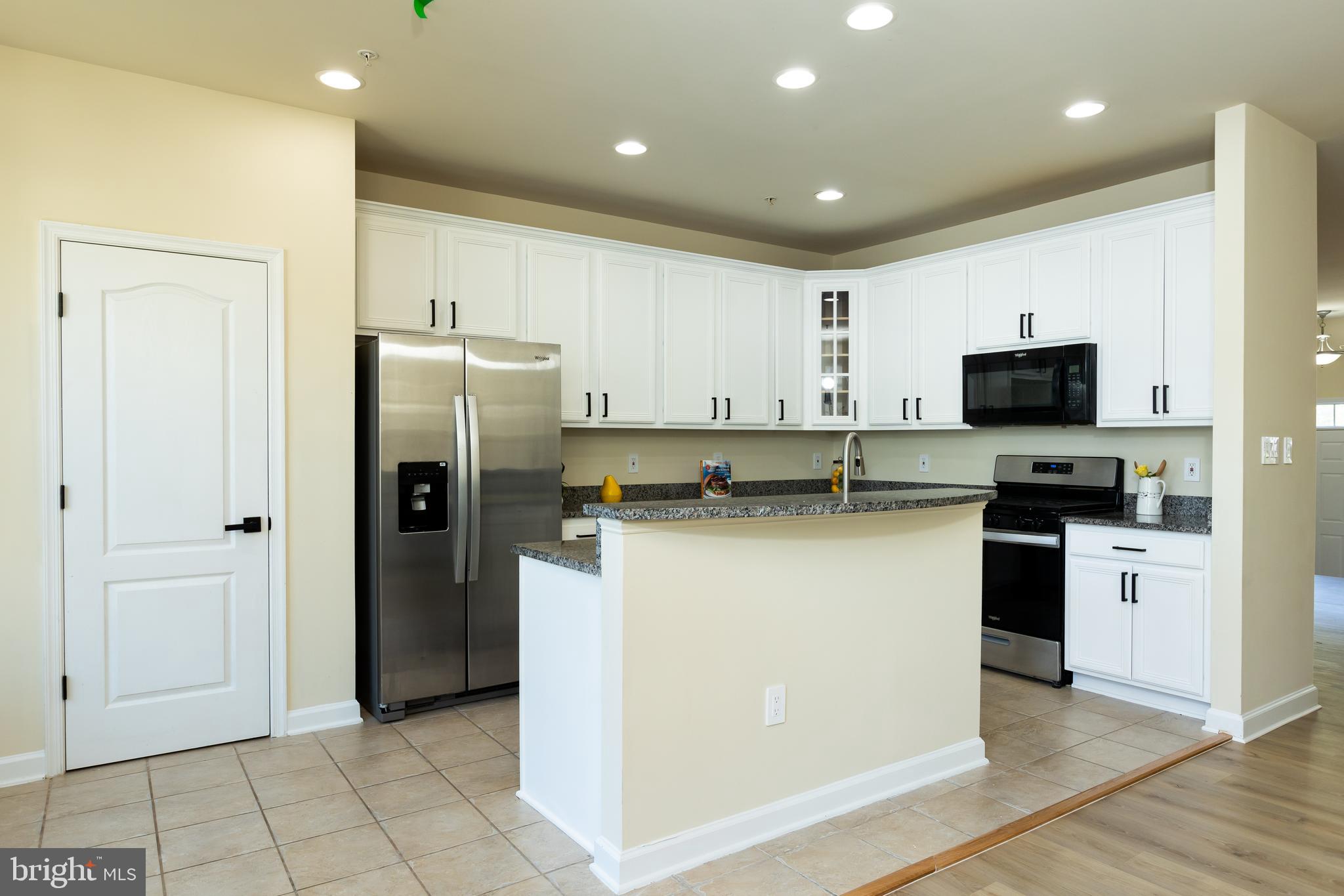 637 Spectator Avenue Landover, MD 20785 - Photo 14 of 54 a kitchen with stainless steel appliances granite countertop a refrigerator a stove a microwave and a refrigerator