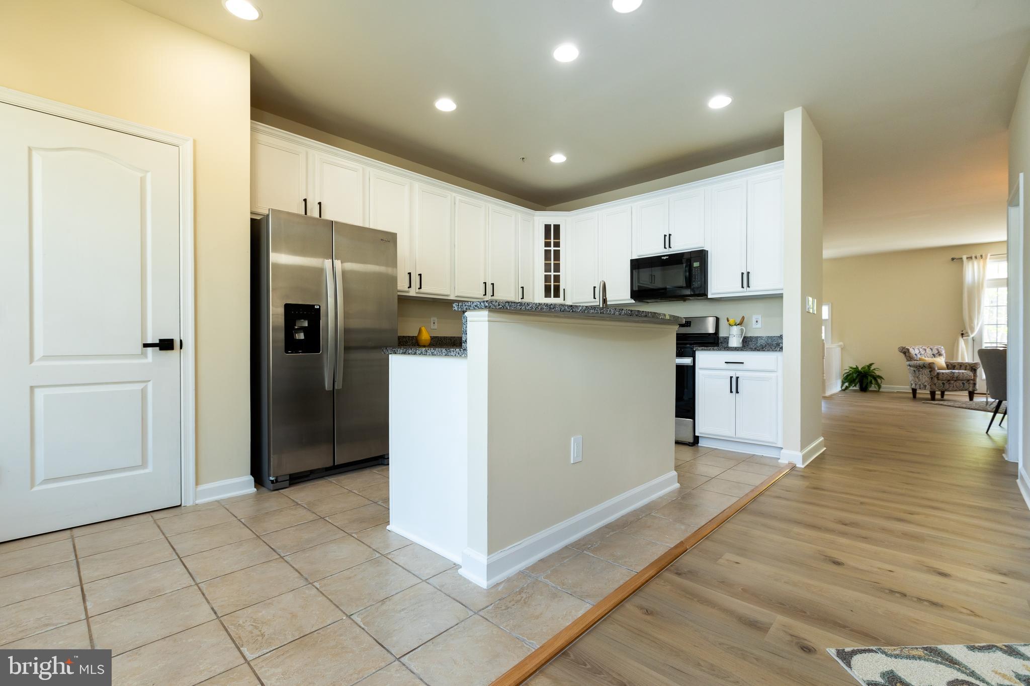 637 Spectator Avenue Landover, MD 20785 - Photo 19 of 54 a kitchen with stainless steel appliances a refrigerator and a stove top oven