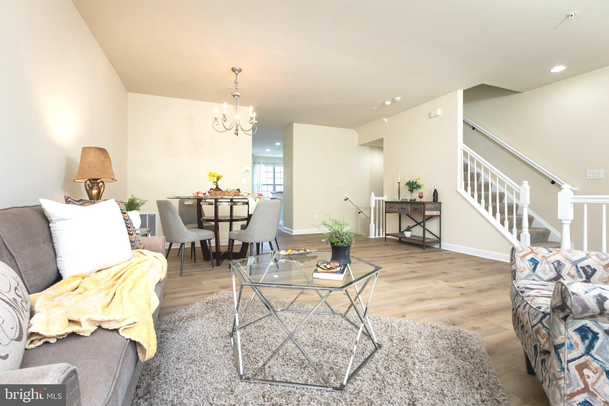 637 Spectator Avenue Landover, MD 20785 - Photo 3 of 54 a living room with furniture and a chandelier