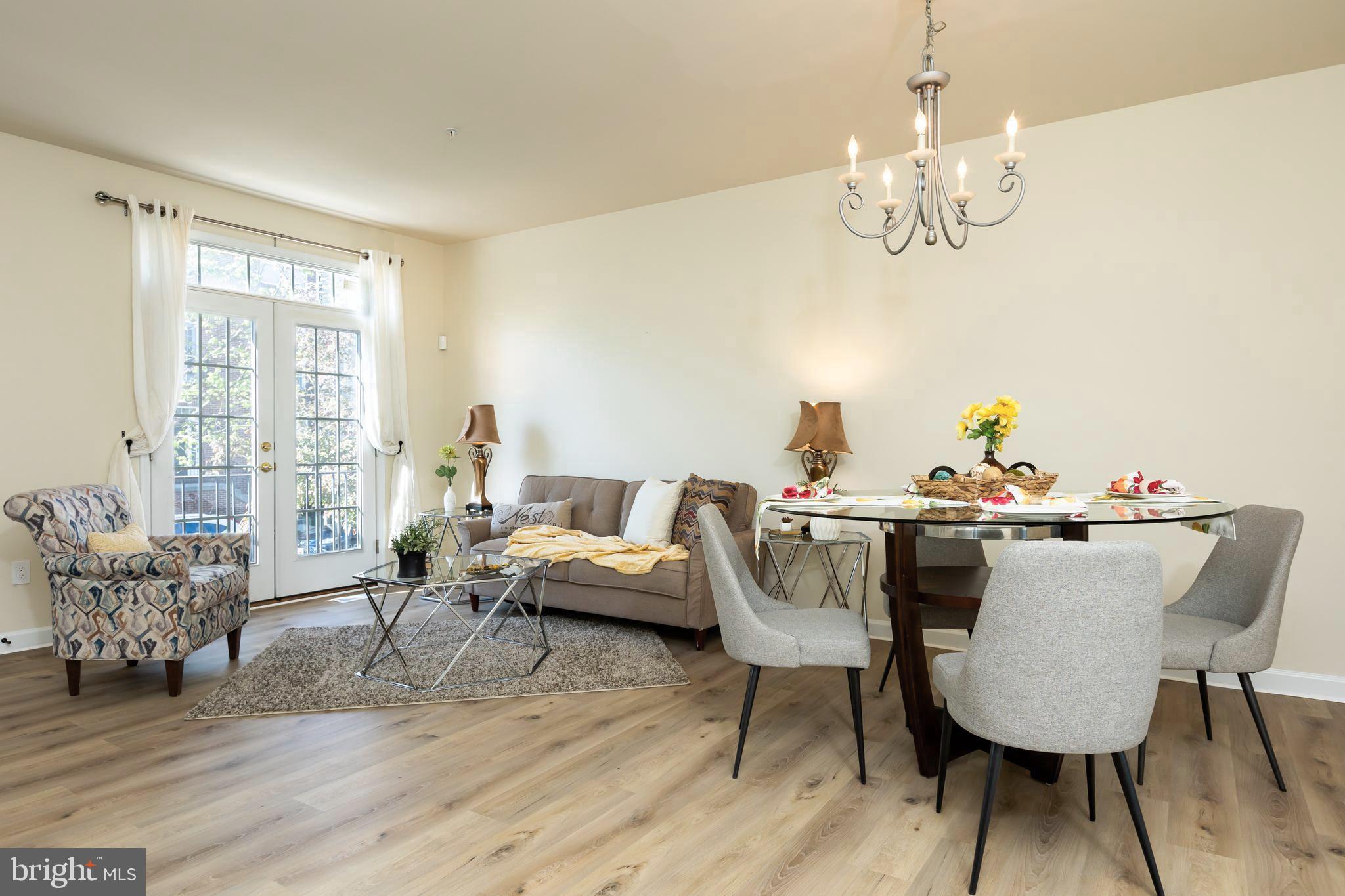 637 Spectator Avenue Landover, MD 20785 - Photo 4 of 54 a view of a dining room with furniture wooden floor and chandelier