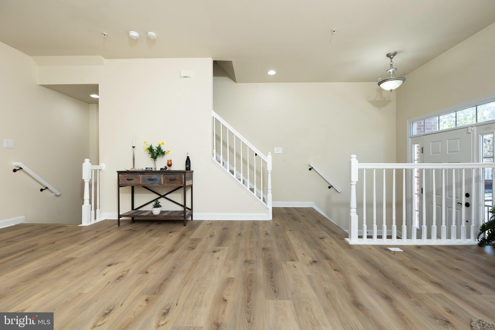 637 Spectator Avenue Landover, MD 20785 - Photo 10 of 54 a view of an empty room with wooden floor and a bathroom