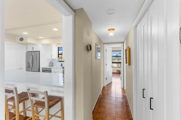 a view of a hallway with wooden floor and windows