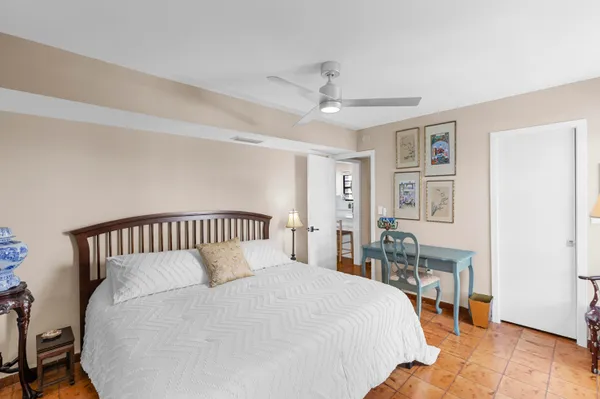 a bedroom with a large bed and a chandelier