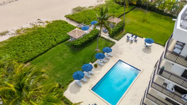 an aerial view of a house with a yard basket ball court and outdoor seating