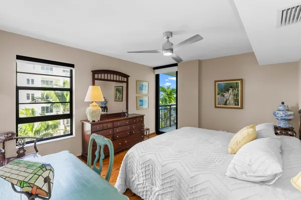 a bedroom with a bed and a large window