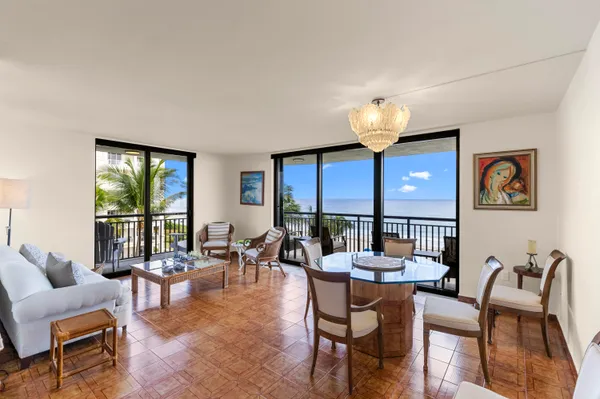 a living room with furniture a fireplace and a potted plant