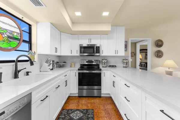 a kitchen with stainless steel appliances a stove sink and cabinets