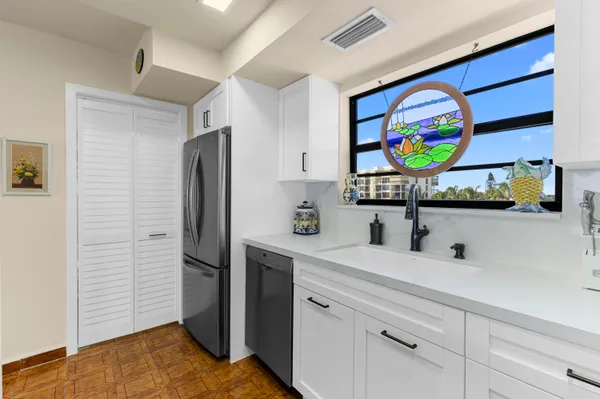 a kitchen with stainless steel appliances granite countertop a refrigerator and a sink