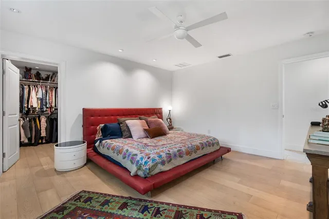 a bedroom with a bed and flat screen tv