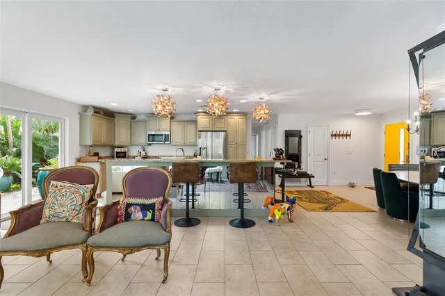 a living room with lots of furniture and a chandelier
