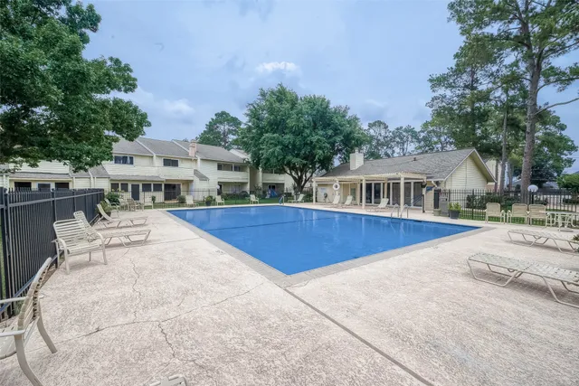 a view of house with outdoor space and swimming pool