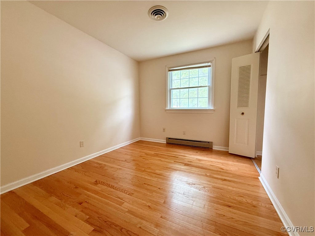 1410 Warminster Drive Midlothian, VA 23113 - Photo 16 of 22 a view of an empty room with wooden floor and a window