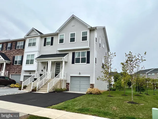a front view of a house with a garden and yard