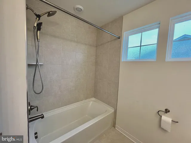 a bathroom with a bath tub with a shower
